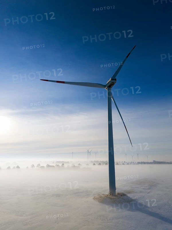 A wind turbine stands out in a snowy, foggy landscape, surrounded by soft morning light and clear sky, aerial view, wind turbine in snow in fog, between Bülten and Solschen, Ilsede, Peine district, Lower Saxony, Germany
