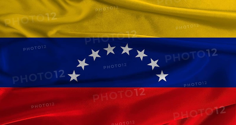 Flag of Venezuela with fabric textured background. Close up of National flag of Venezuela with realistic texture