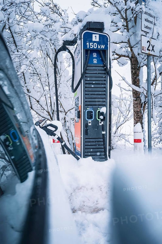 150 kW charging station in snowy surroundings next to an electric car, Tesla Model Y electric car, ENBW charging station, Waldachtal, Freudenstadt district, Germany