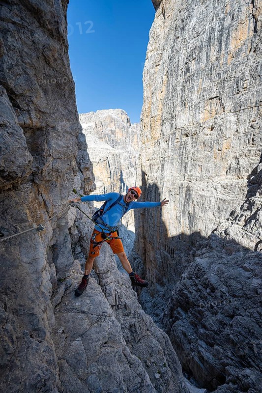 Mountaineers happy on the Via Ferrata Bocciere Centrale via ferrata, spectacular mountain landscape with steep rock faces, Brenta Mountains, Parco Naturale Brenta-Adamello, Trentino, Italy