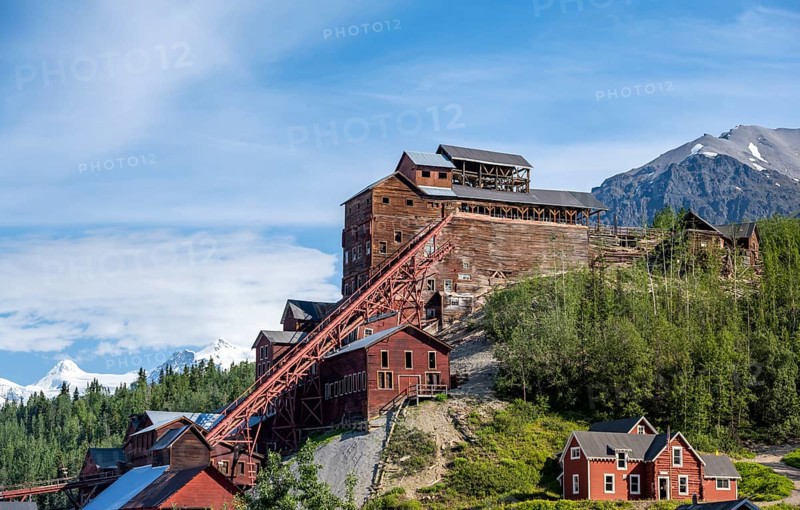 Red Kennicott buildings in front of mountainous landscape, Kennicott Concentration Mill to extract copper from quarried rock, Historic Kennecott Copper Mine, National Historic Landmark, Wrangell St. Elias National Park, Alaska, USA