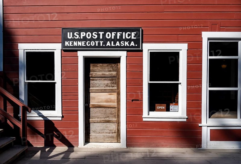 Red Kennicott buildings against mountainous landscape, Kennecott Post Office, Historic Kennecott Copper Mine, National Historic Landmark, Wrangell St. Elias National Park, Alaska, USA