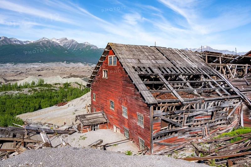 Red dilapidated buildings of Kennicott against mountainous landscape, Historic Kennecott Copper Mine, National Historic Landmark, Wrangell St. Elias National Park, Alaska, USA