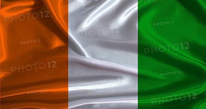 Ivory Coast flag with cloth textured background. National flag of Ivory Coast with realistic texture
