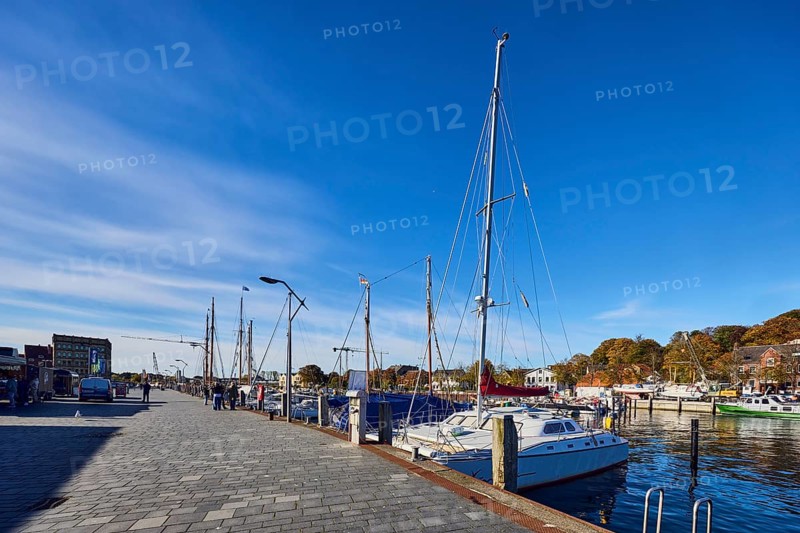 Harbour, harbour basin, wharf, ships, sailboat, duckdalves, general architecture, houses, lantern, trees, pedestrians as accessories, blue sky, cirrus clouds, Hafenstraße road, Eckernförde district, Rendsburg-Eckernförde, Schleswig-Holstein, Germany