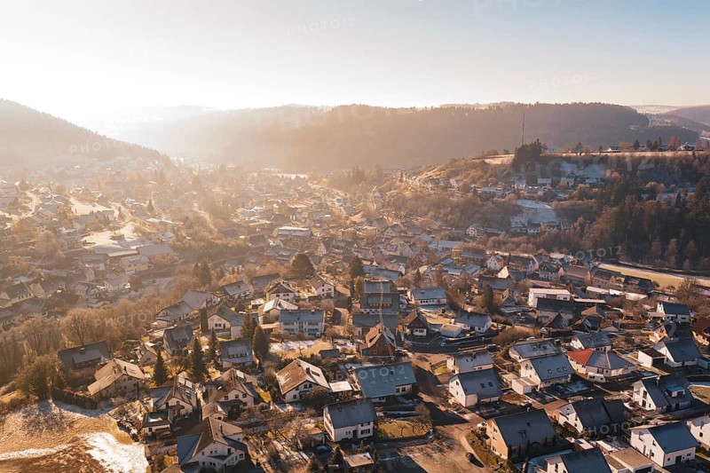Overview of a village with wintry roofs and hills, Glatten, Freudenstadt district, Germany