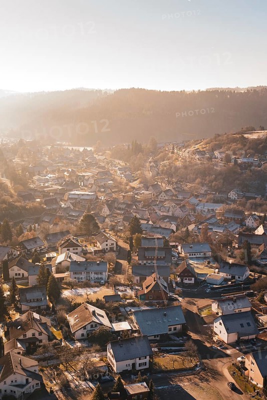 A village in a hilly landscape in the warm light of sunset, Glatten, Freudenstadt district, Germany
