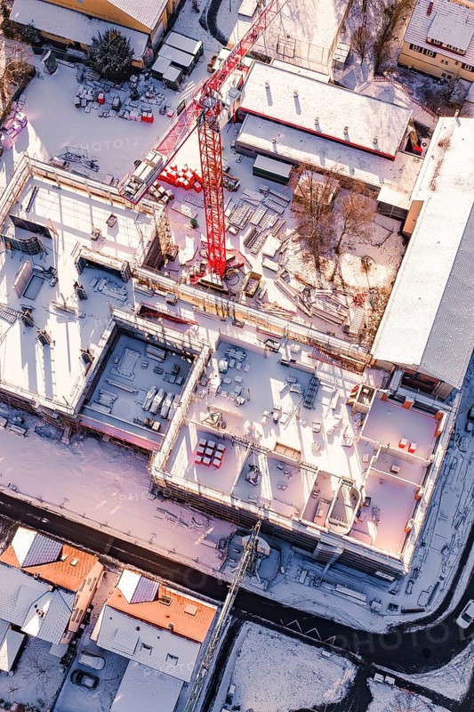 Detailed view of a snowy construction site with visible building materials, Zellerschule new building, Nagold, Black Forest, Germany