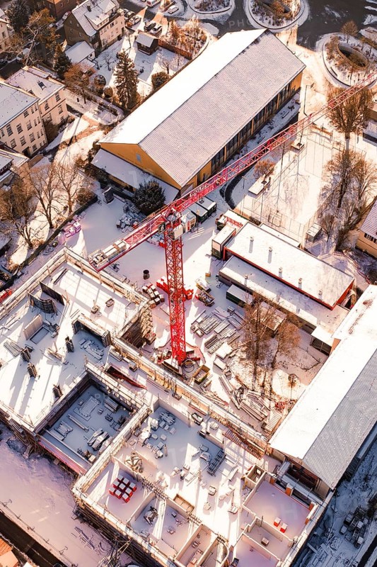 Detailed aerial view of a construction site in a snowy urban landscape, Zellerschule building, Nagold, Black Forest, Germany