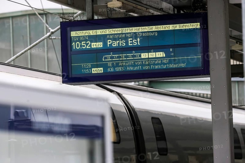 Winter in Stuttgart. There is also a closed layer of snow in the main train station. TGV on the platform with information board for departure to Paris. Stuttgart, Baden-Württemberg, Germany