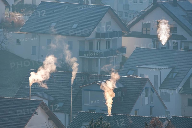 Sunrise over a village with smoking chimneys, calming morning atmosphere, symbolic image, fireplaces, gas heating, oil heating, fossil fuels, climate change, global warming, chimneys, Baden-Württemberg, Germany