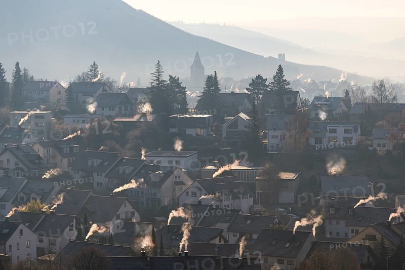 Extensive village panorama with smoking chimneys and hills in the morning haze, symbolic image, fireplaces, gas heating, oil heating, fossil fuels, climate change, global warming, chimneys, Baden-Württemberg, Germany