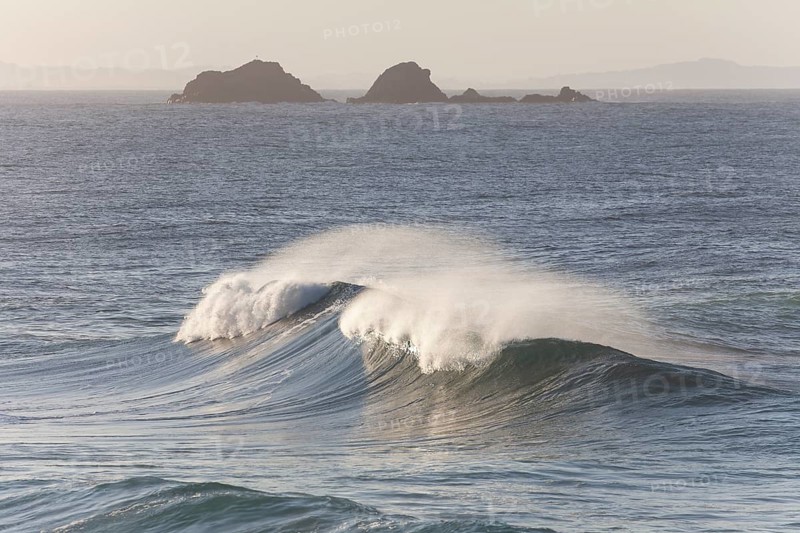 Looking towards Julian Rocks Nature Reserve across the breaking waves. Ocean view, Byron Bay, New South Wales, Australia