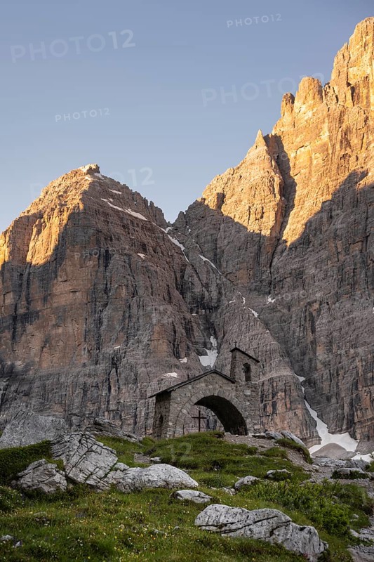 Cappella Ai Brentei chapel Memorial for injured mountaineers at the Rifugio Ai Brentei mountain hut, rocky peaks at sunrise with alpine glow, picturesque mountain landscape, Brenta, Trentino, Italy