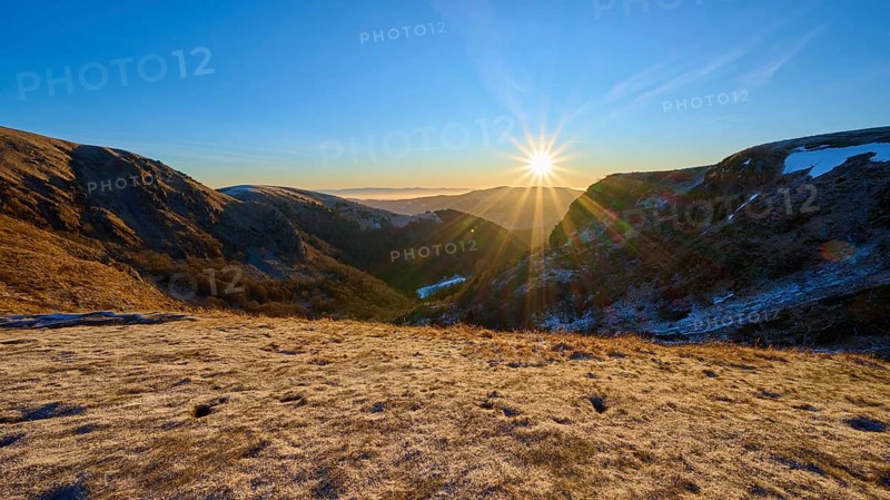 Frosty mountain landscape at sunrise with bright sunlight and clear sky, winter, Route de Cretes, Hohneck, La Bresse, Vosges, France