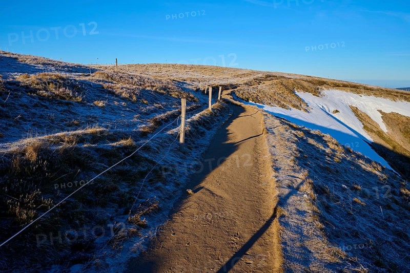 A frosty trail leads into the wintry expanse, accompanied by blue skies, winter, Route de Cretes, Hohneck, La Bresse, Vosges, France