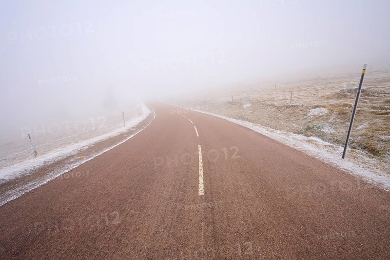 Winding road hidden in thick fog, winter, Route de Cretes, Hohneck, La Bresse, Vosges, France