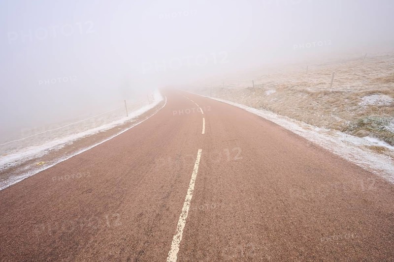 Gentle curve of a road in thick fog, winter, Route de Cretes, Hohneck, La Bresse, Vosges, France