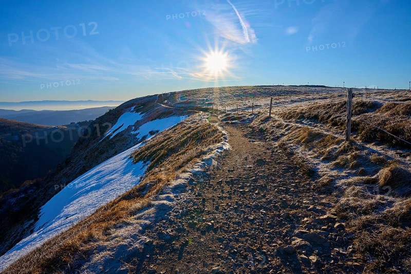 Snowy trail on a ridge at sunrise, clear view with frosty landscape, winter, Route de Cretes, Hohneck, La Bresse, Vosges, France