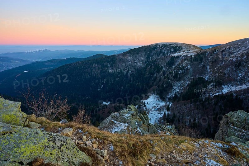 Snowy hills and rocks in warm evening light, view of the Rhine Valley, viewpoint, La Gorge de Pierrel, Martinswand, Frankental, Vosges, France