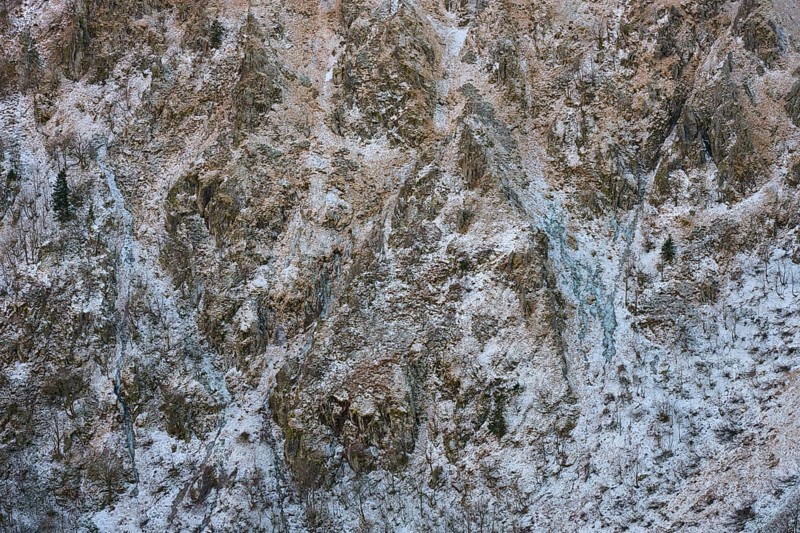 Rocky, snowy mountain wall with complex texture and cold winter atmosphere, Hohneck, La Bresse, Vosges, France