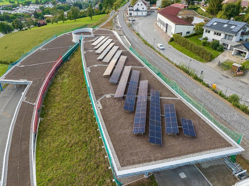 Solar panels on a roof in a green area with several residential buildings, new Park and Ride Calw Heumaden car park on the new Hermann Hessebahn, Calw, Germany