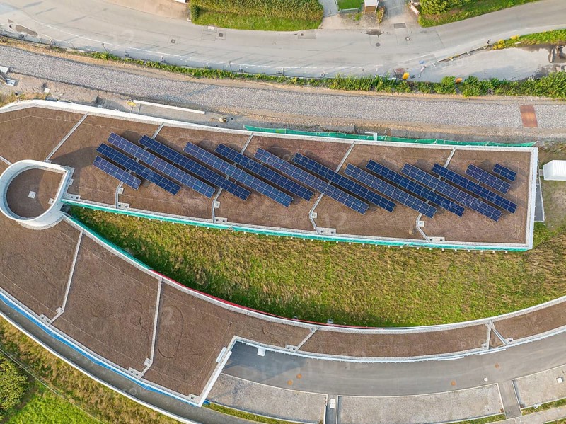 Aerial view of a solar roof in an urban area surrounded by roads, new park and ride parking garage Calw Heumaden on the new Hermann Hessebahn, Calw, Germany