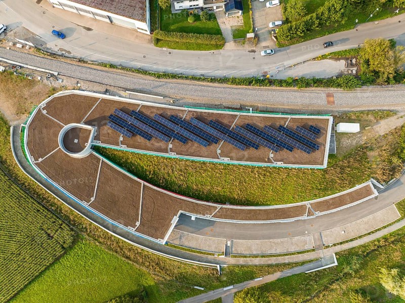 Aerial view of a solar cell field on a roof with surrounding roads, new Park and Ride parking garage Calw Heumaden on the new Hermann Hessebahn, Calw, Germany
