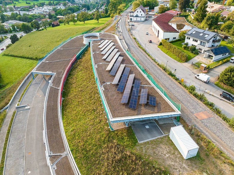House roof with several solar panels surrounded by green landscape, new park and ride parking garage Calw Heumaden on the new Hermann Hessebahn, Calw, Germany