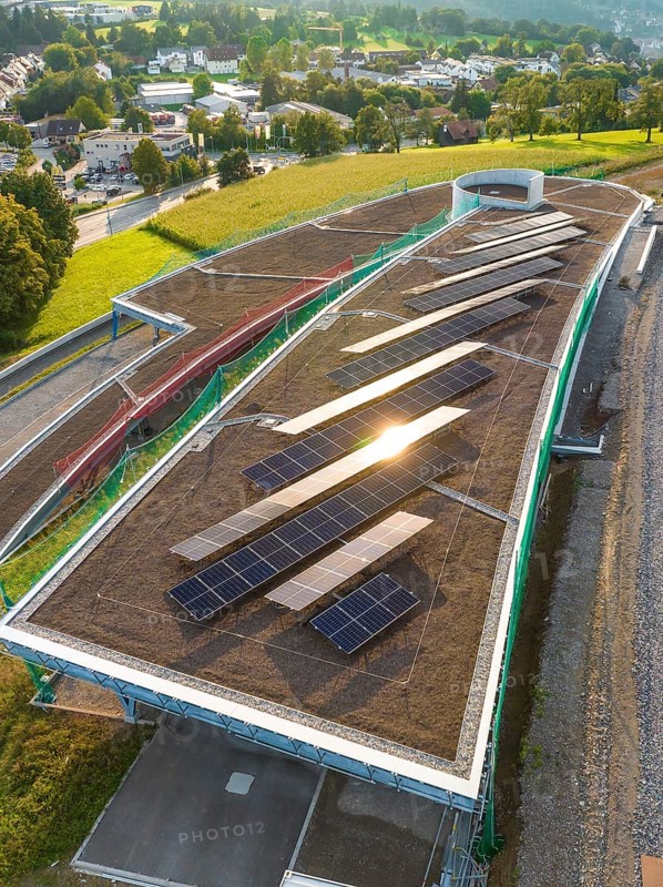 A roof area with solar panels, illuminated by the evening sun, in a rural area, new park and ride parking garage Calw Heumaden on the new Hermann Hessebahn, Calw, Germany