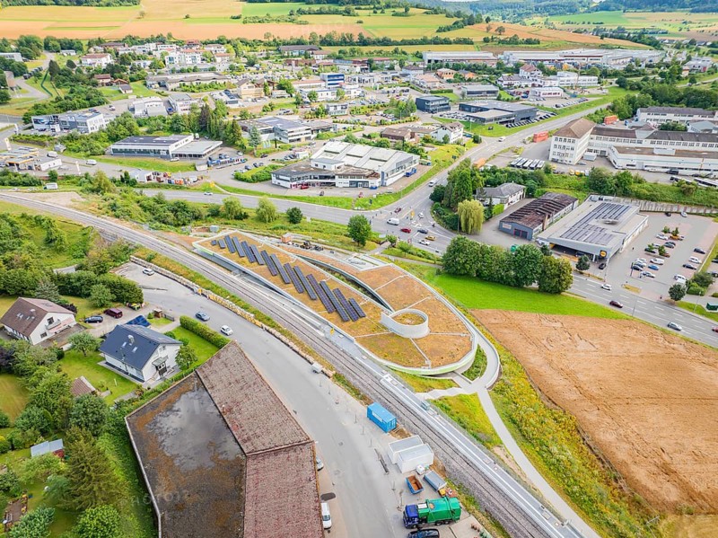 Urban landscape with solar panels along a street in a busy area, new park and ride parking garage Calw Heumaden on the new Hermann Hessebahn, Calw, Germany