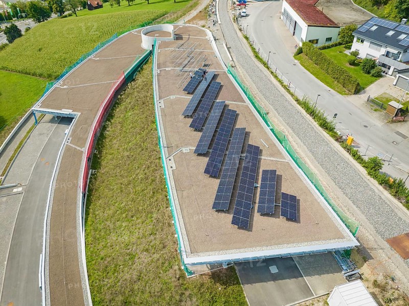 Solar system on buildings surrounded by infrastructure and roads, new park and ride parking garage Calw Heumaden on the new Hermann Hessebahn, Calw, Germany
