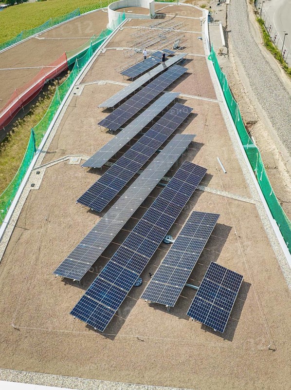 Solar panels on a roof viewed from above, surrounded by buildings, new park and ride parking garage Calw Heumaden on the new Hermann Hessebahn, Calw, Germany