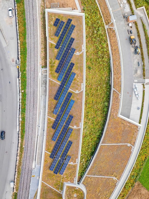 Aerial view of solar roof area in an urban area with plants and paths, new park and ride parking garage Calw Heumaden on the new Hermann Hessebahn, Calw, Germany