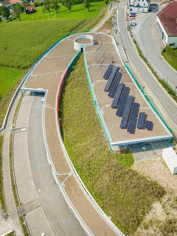 Round road layout next to solar panel system on a roof, new Park and Ride Calw Heumaden car park on the new Hermann Hessebahn, Calw, Germany