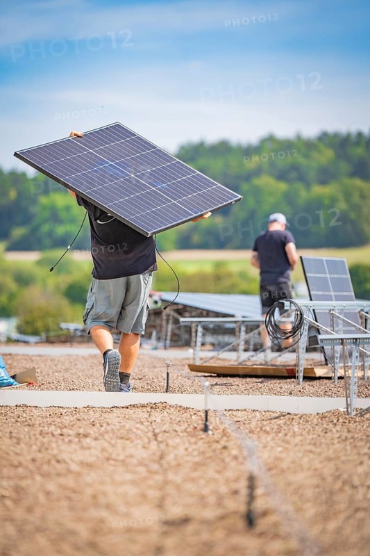 Workers transport and install solar panels in the open air, new park and ride Calw Heumaden car park on the new Hermann Hessebahn, Calw, Germany