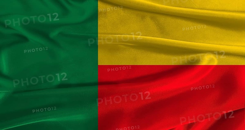Flag of Benin with fabric textured background. Close up of National flag of Benin with realistic texture
