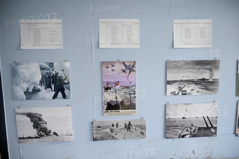 Wall with war pictures and documents in black and white in the partisan museum in the old school of Kiberg on a wooden wall, Kiberg, Troms, Norway