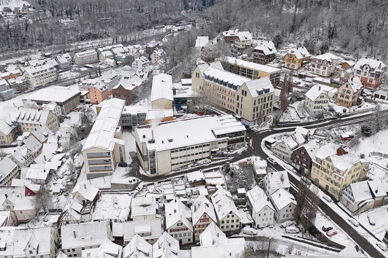 Bird's eye view of snowy town with hills and roads, Calw, Black Forest, Germany
