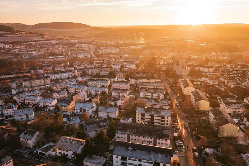 View of an urban landscape at sunset, with highly visible hills in the background, Calw, Black Forest, Germany
