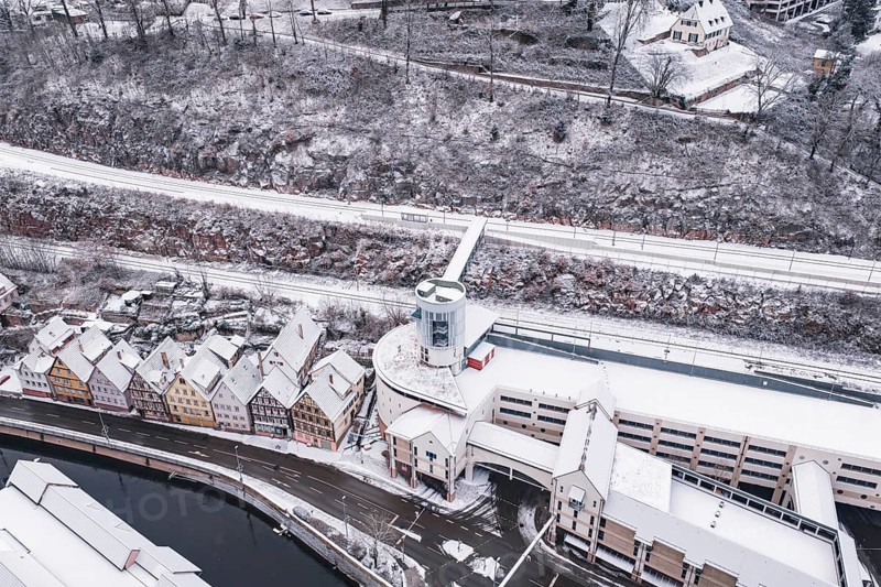 Snowy city view with bridge over a river and traditional architecture, Calw, Black Forest, Germany