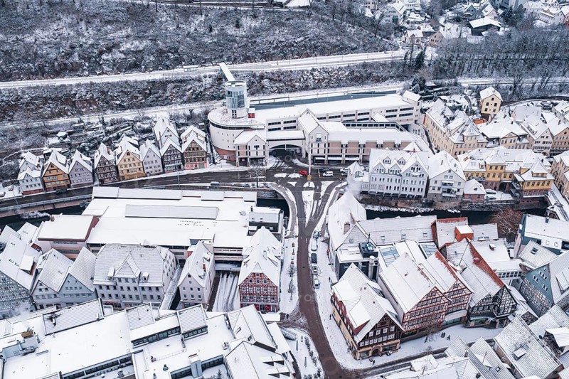 Aerial view of a snowy town with half-timbered houses and roads in winter, Calw, Black Forest, Germany