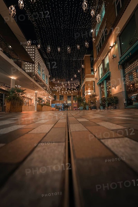 Paved street with fairy lights and urban flair in a friendly evening mood, London, England, Great Britain