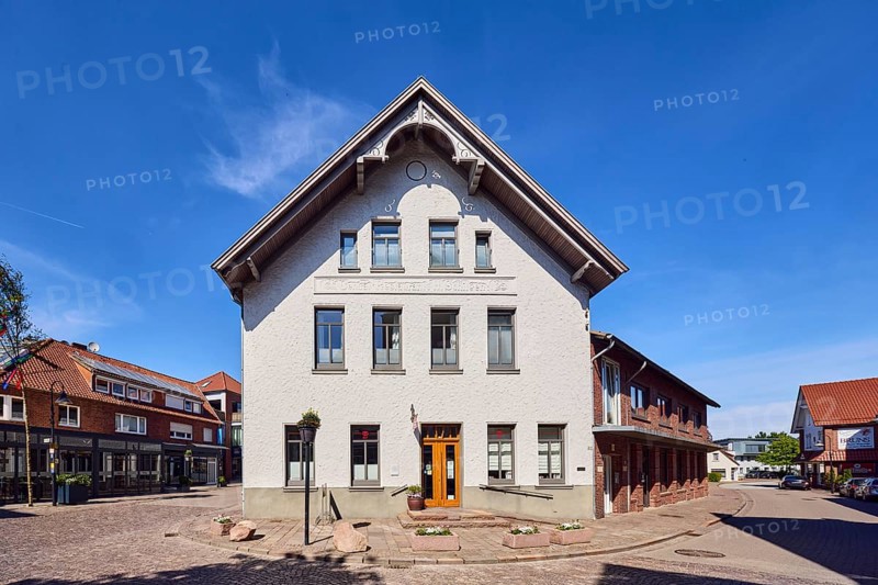 Social department store Kleines Kaufhaus Damme, general architecture, commercial buildings, houses, façade with windows, entrance with entrance door, street made of paving stones, blue sky, cirrus clouds, intersection Große Straße, Friedhofstraße and Gartenstraße, Damme, district of Vechta, Lower Saxony, Germany