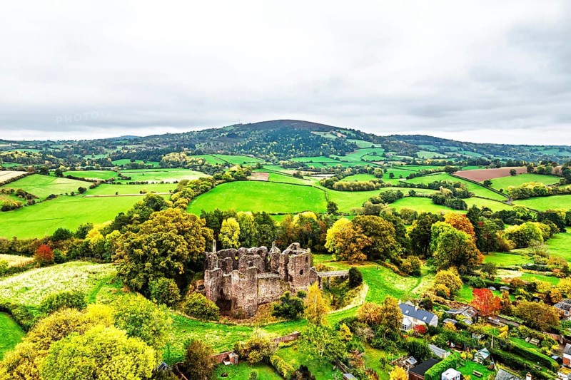 Autumn Colours over ruins of Grosmont Castle from a drone, Grosmont, Monmouthshire, Wales, UK
