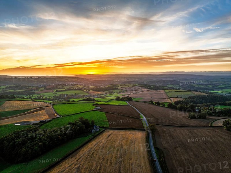 Sunset of Devon Farms and Fields over Berry Pomeroy from a drone, Totnes, England, United Kingdom