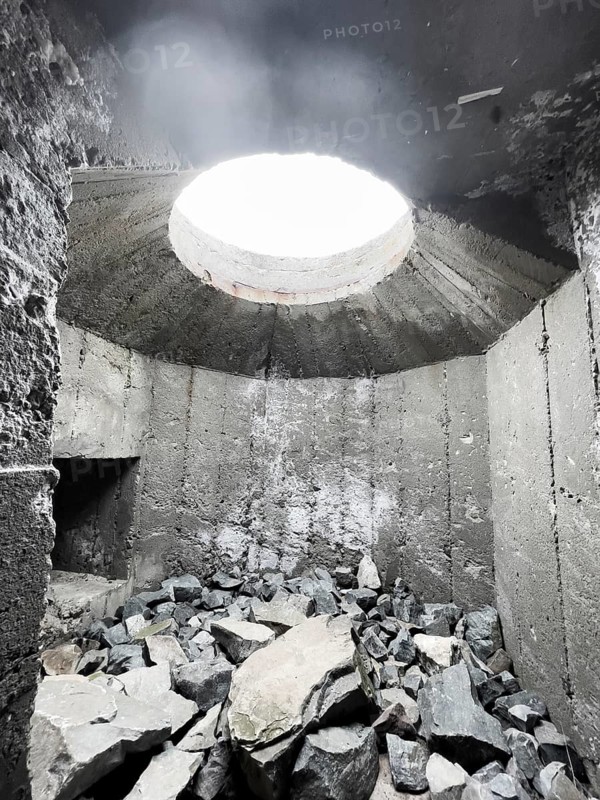 Old Wehrmacht anti-aircraft bunker from the Second World War with worn stairs in a dilapidated, dark environment, Båtsfjord, Finnmark, Norway