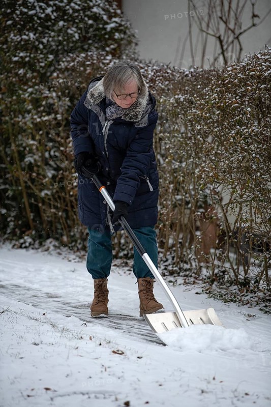 Elderly woman sweeping week with snow shovel, snow shovel, snow remover, shovel, clear, shovel snow, sidewalk, snowfall, snow, winter, Stuttgart, Baden-Württemberg, Germany