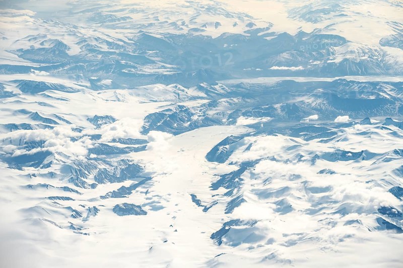 Icy, snowy arctic mountain landscape with glaciers, aerial view, Greenland, Arctic