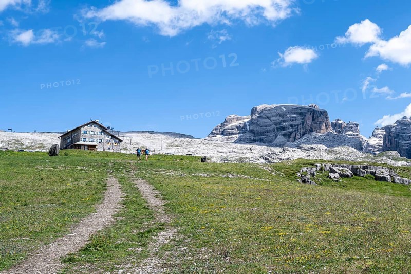 Hikers in front of Rifugio Graffer, Brenta, Brenta-Adamello Natural Park, Trentino, Italy
